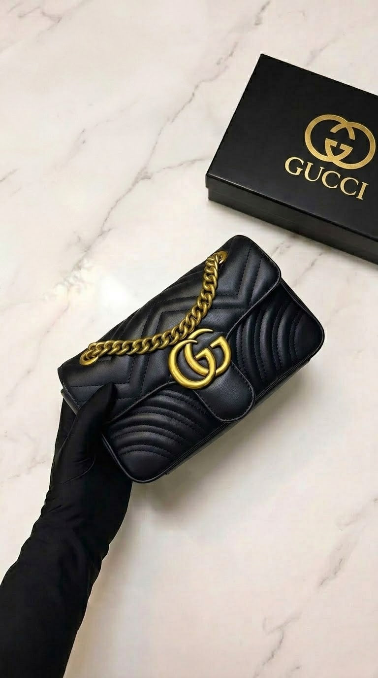Gucci GG Marmont shoulder bag, featuring quilted black leather and gold-tone hardware.