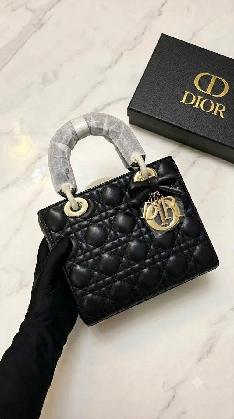 Black lambskin Dior Lady Dior bag featuring iconic Cannage stitching and gold-finish metal charms