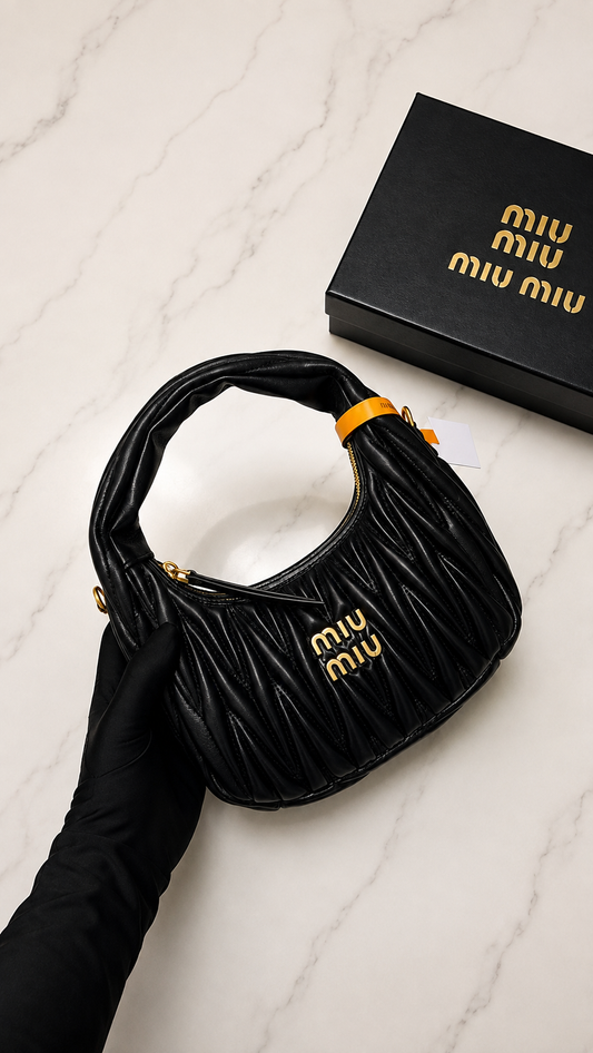Miu Miu Wander bag in black Matelassé nappa leather with gold-tone logo lettering.